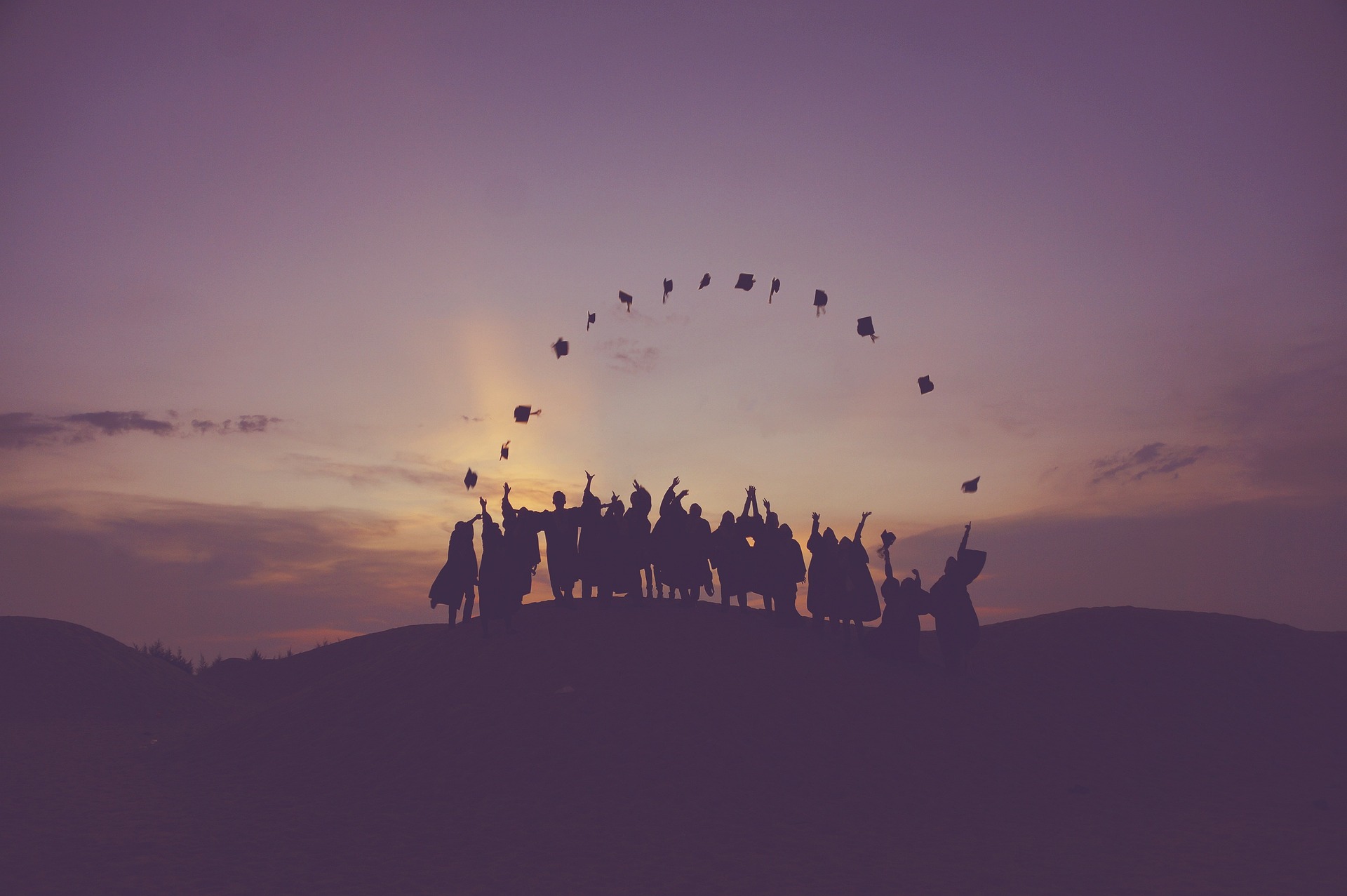 graduates tossing hats in the air